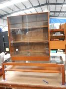 A teak bookcase and a teak coffee table.