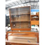 A teak bookcase and a teak coffee table.