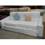 A large white leather bed settee.