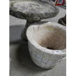 A concrete bird bath and planter.