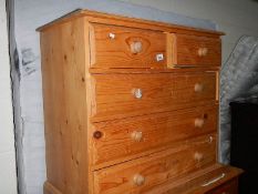 A pine 2 over 3 chest of drawers.