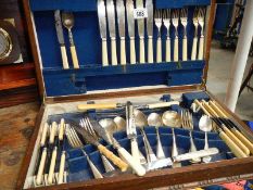 An oak cased canteen of cutlery.