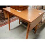 A teak drop leaf table.