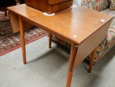 A teak drop leaf table.