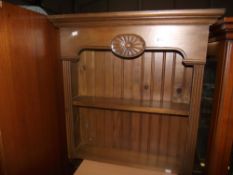 A dark stained pine kitchen wall shelf unit