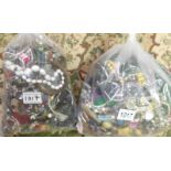 A quantity of costume jewellery in 2 bags, approximately 7 kg.
