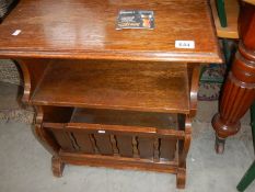 A 1930/50's oak magazine rack, and a vase side table.