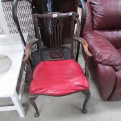 A mahogany ball and claw arm chair.