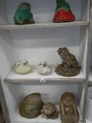 3 shelves of garden ornaments.