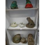 3 shelves of garden ornaments.