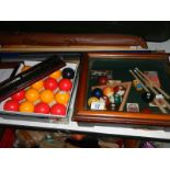 A billiards display cabinet, cues, balls and scoreboard.
