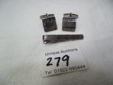 A pair of silver cufflinks and matching tie-pin