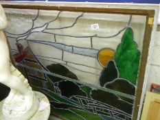 A wood framed leaded and stained glass window,