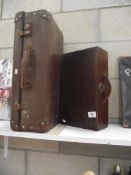 A leather travel case and a wooden case