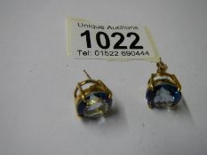 A pair of yellow gold and topaz earrings.