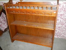 A pair of oak carved top book cases.