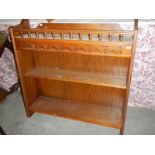 A pair of oak carved top book cases.