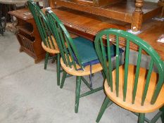 A set of 4 green painted kitchen chairs.