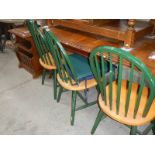 A set of 4 green painted kitchen chairs.