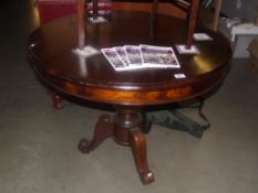 A round mahogany tripod tea / dining table