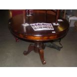 A round mahogany tripod tea / dining table