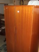 A 1970s teak veneered double wardrobe