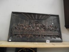 A cast iron plaque of a Christian scene depicting the last supper