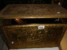 A brass log box and a warming pan.