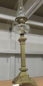 A Victorian brass column oil lamp with cut glass font.