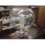 A large glass fish bowl candle holder