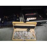 A Bosch cast with sander, box of wood drill bits, boxed drill with battery and empty case.