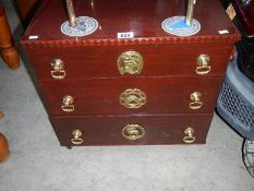 A 3 drawer chest with brass fittings.