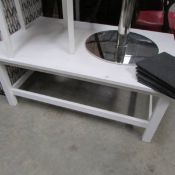 A rectangular white square legged table.