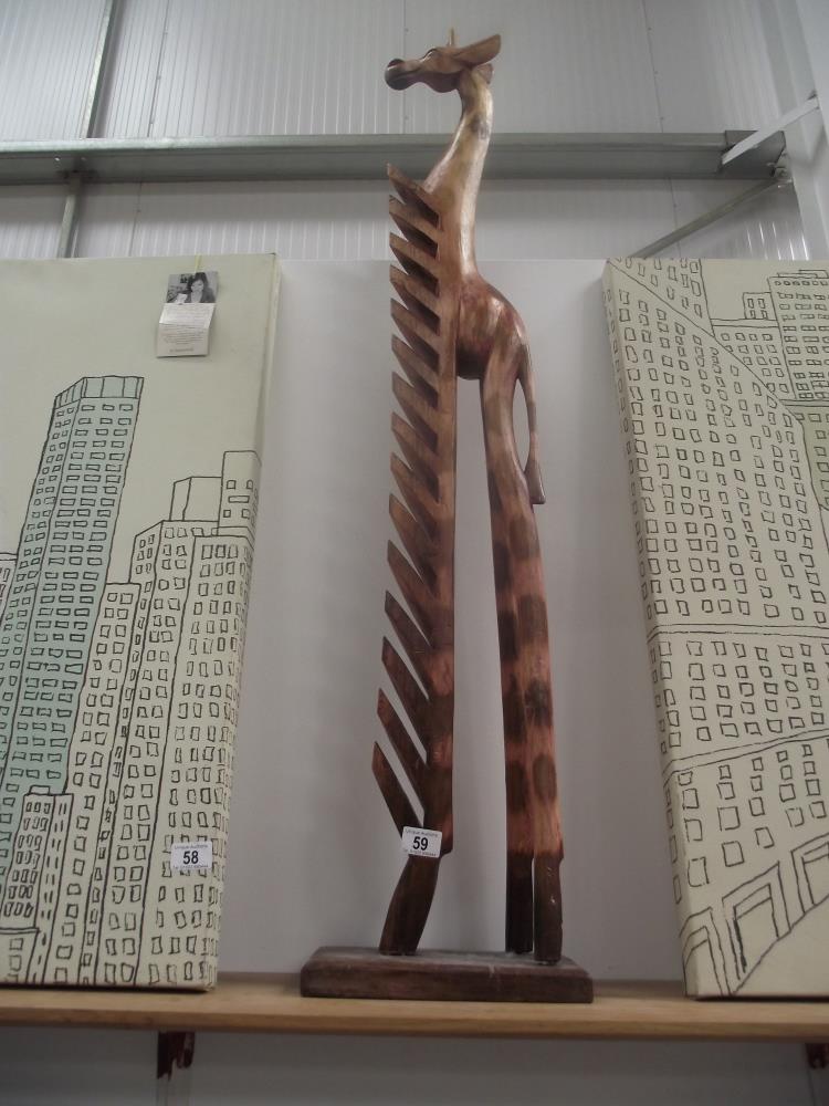 A wooden giraffe cd holder