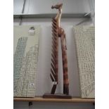 A wooden giraffe cd holder