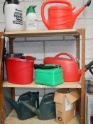 3 shelves of watering cans etc.