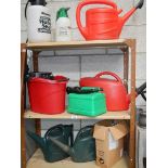 3 shelves of watering cans etc.