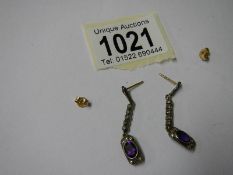 A pair of amethyst and diamond drop earrings.