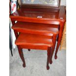 A nest of 3 mahogany tables.