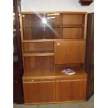 A 1970s teak sideboard with smoke glass sliding doors