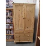 A pine double wardrobe with 3 drawers in base