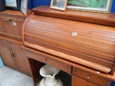 A modern pine roll top desk.