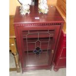 A darkwood stained glass cabinet