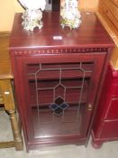 A darkwood stained glass cabinet