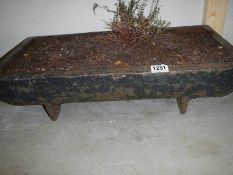 An oblong cast iron planter, 24" x 12" x 7".