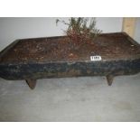 An oblong cast iron planter, 24" x 12" x 7".