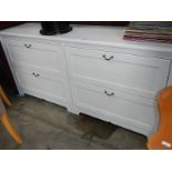 A long white 4 drawer chest.
