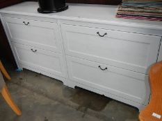 A long white 4 drawer chest.