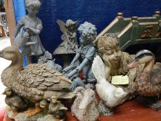 A quantity of bird and figures garden ornaments.