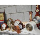 A large shelf of mantel clocks.